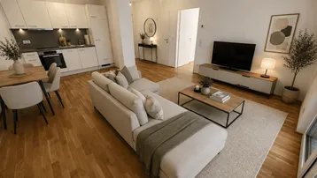 Moderner offener Wohn- und Essbereich mit integrierter Küche, Holzboden und Zugang zum Balkon.