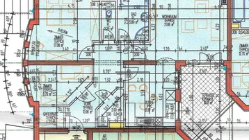 Grundriss einer Eckwohnung im Erdgeschoss mit mehreren Zimmern, separatem WC, Küche und einer großzügigen Terrasse.