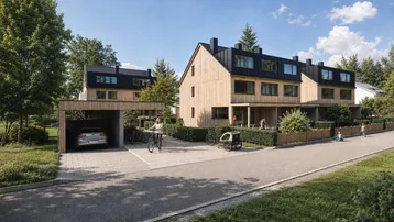 Moderne Reihenhäuser mit Holzfassade, Carport und gepflegter Außenanlage in grüner Umgebung.