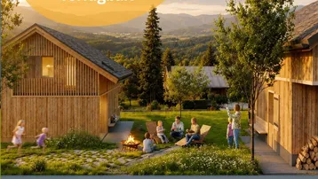 Gemütlicher Außenbereich zwischen Holzhäusern mit Feuerstelle und Blick auf die umliegende Berglandschaft.