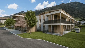 Neubauwohnungen in alpiner Umgebung mit modernen Balkonen und Fahrradabstellplätzen.