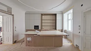 Helle Küche im Rohbau mit bereits installierten Unterschränken und einer Kücheninsel, bereit für den weiteren Ausbau.