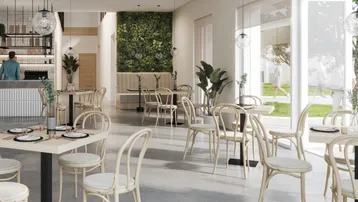 Modernes Restaurant mit hellen Möbeln, grüner Wand und großen Fenstern zum Außenbereich.