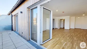 Helles Wohnzimmer mit Zugang zu einer großzügigen Terrasse und Holzelementen an der Fassade.