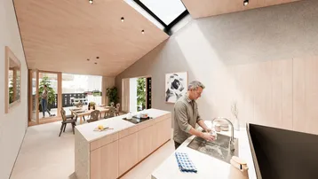 Helle, offene Küche mit Holzdecken, Dachfenstern und integriertem Essbereich.