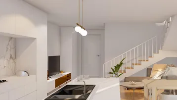Moderne offene Wohnküche mit Kochinsel, Essbereich und Treppenzugang zum Obergeschoss.