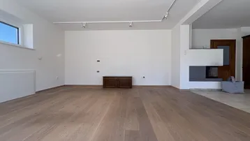 Heller Wohnbereich mit Holzboden und einem modernen Kamin als stilvolles Element im Raum.