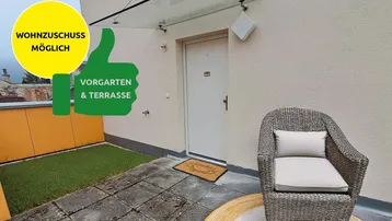 Gemütliche Terrasse mit Sitzgelegenheit und kleinem Vorgartenbereich am Eingang.
