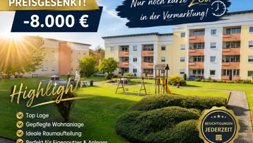 Gepflegte Wohnanlage mit mehreren Gebäuden, großzügigen Grünflächen und einem Kinderspielplatz.