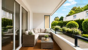 Geräumiger Balkon mit bequemen Outdoor-Möbeln und Blick ins Grüne, ideal zum Entspannen.