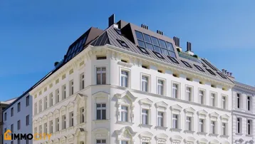 Historische Fassade eines Gebäudes mit modernem Dachausbau und vielen Fenstern.