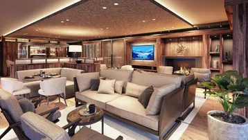 Modernes Wohnzimmer mit gemütlichen Sofas, Kamin und integrierter Bar, ideal für gesellige Abende.