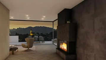 Gemütliches Wohnzimmer mit Kamin, Parkettboden und raumhohen Fenstern mit Bergblick.