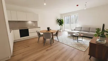 Heller offener Wohn- und Essbereich mit integrierter Küche, Laminatboden und Zugang zum Balkon.