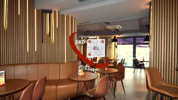 Modern eingerichteter Innenbereich eines Restaurants oder einer Bar mit gemütlichen Sitzgelegenheiten und stilvoller Beleuchtung.