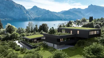 Moderne Architektur mit Flachdach und begrünten Terrassen, eingebettet in eine beeindruckende Berg- und Seenlandschaft.