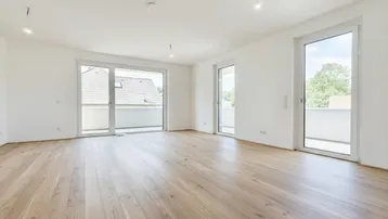 Helles, geräumiges Zimmer mit neuem Holzboden und Zugang zu zwei Balkonen, ideal für Wohnbereiche.