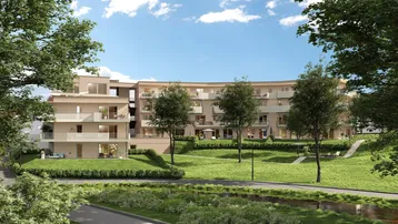 Moderne Wohnanlage eingebettet in eine weitläufige Grünfläche mit Bäumen.