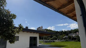 Sonniger Außenbereich mit Pool und gepflasterter Terrasse, ideal zum Entspannen.