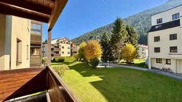 Balkon mit weitem Blick auf grüne Wiesen und die umliegenden Berge.