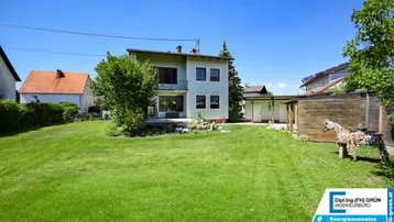 Großzügiger Gartenbereich mit Rasenfläche und Blick auf das Einfamilienhaus.
