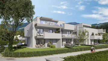 Moderne Wohnanlage mit mehreren Balkonen und Terrassen in grüner Umgebung und Bergblick.