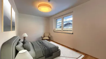 Helles Schlafzimmer mit Holzboden, großem Bett und Blick auf die Umgebung.