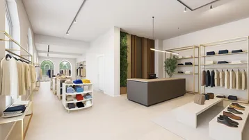 Modernes Ladengeschäft mit heller Einrichtung, goldenen Regalen und einer grünen Wanddekoration.