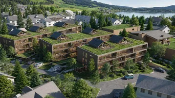Moderne Wohngebäude mit begrünten Dächern und Balkonen in Seenähe, umgeben von Natur.