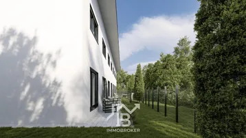 Moderne Reihenhausfassade mit kleiner Terrasse und umzäuntem Grünbereich.