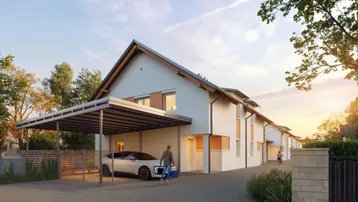 Modernes Reihenhaus mit Satteldach, Carport und gepflegter Außenanlage bei Sonnenuntergang.