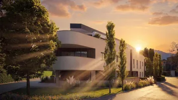 Moderne Architektur bei Sonnenuntergang mit gepflegter Außenanlage und Bäumen.