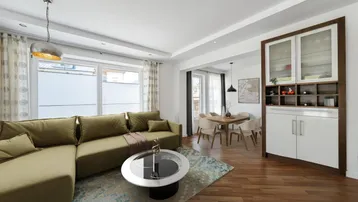 Helles Wohn- und Esszimmer mit modernem Sofa, Holzboden und integriertem Schrank.