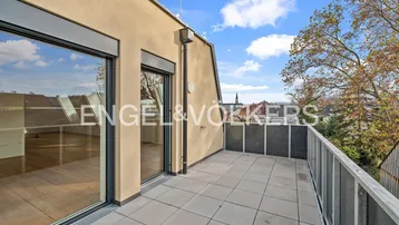 Geräumige Terrasse mit Fliesenboden und Blick auf die umliegende Stadtlandschaft.