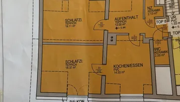 Grundrissplan einer Wohnung mit zwei Schlafzimmern, offener Küche und Balkon.