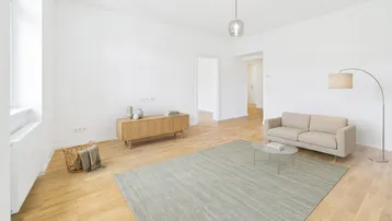 Helles Wohnzimmer mit Parkettboden, modernem Teppich und schlichten Möbeln, ideal für entspannte Stunden.