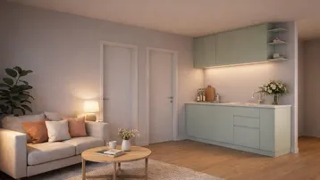 Gemütlicher Wohnbereich mit integrierter Küchenzeile und hellem Parkettboden, ideal für modernes Wohnen.