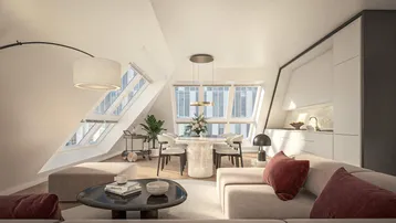 Modernes Dachgeschoss-Apartment mit offenem Wohn-, Ess- und Kochbereich unter schrägen Dachfenstern.