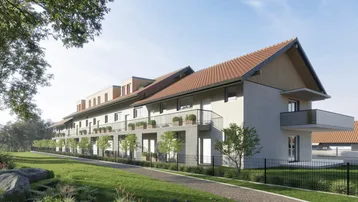 Modernes Mehrfamilienhaus mit Balkonen und grüner Umgebung unter blauem Himmel.