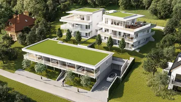 Moderne Wohngebäude mit begrünten Flachdächern und Balkonen, eingebettet in eine grüne Landschaft.