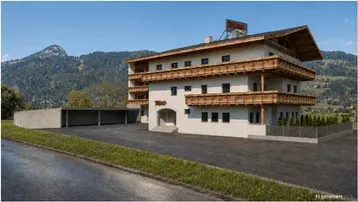 Modernes Gebäude im alpinen Stil mit Holzfassade und Balkonen vor einer beeindruckenden Bergkulisse.
