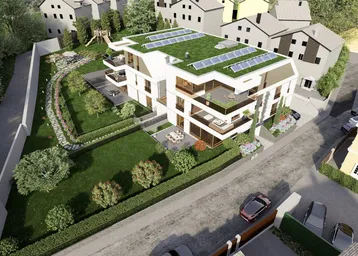 Moderne Wohnanlage mit Gründach, Solarpaneelen, Balkonen und großzügigen Grünflächen in einer Wohnsiedlung.