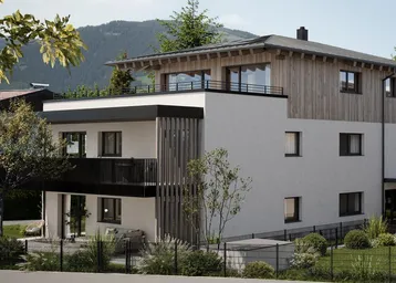 Moderne Architektur mit Holz- und Putzfassade vor bergiger Kulisse und Grünflächen.
