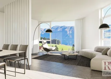 Helles, modernes Wohn-Esszimmer mit großen Fenstern, die einen atemberaubenden Blick auf den See und die Berge bieten.