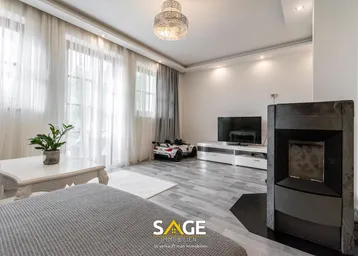 Helles Wohnzimmer mit modernem Kamin, großen Fenstern und stilvoller Einrichtung.