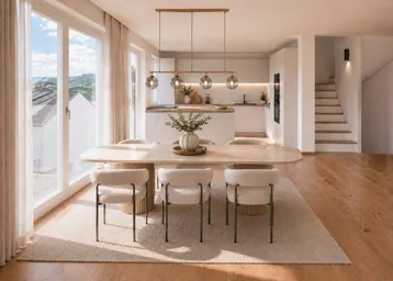 Moderne, offene Wohnküche mit großem Esstisch, Holzboden und weitem Ausblick.
