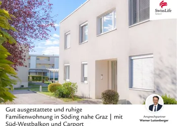 Modernes Wohngebäude mit heller Fassade und großen Fenstern in einer ruhigen Wohngegend.