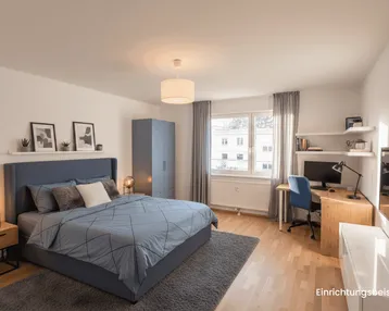 Helles Schlafzimmer mit modernem Bett, Schreibtisch und Blick ins Grüne.