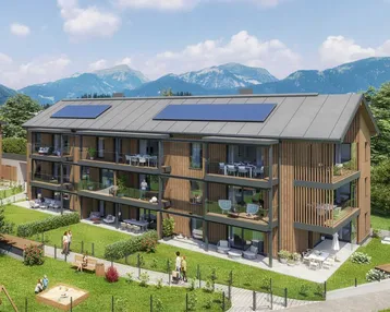 Modernes Mehrfamilienhaus mit Holzfassade, Balkonen, Solarpaneelen und Bergblick in grüner Umgebung.