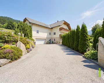 Charmantes Haus mit gepflegtem Garten, langer Auffahrt und Bergblick in sonniger Lage.